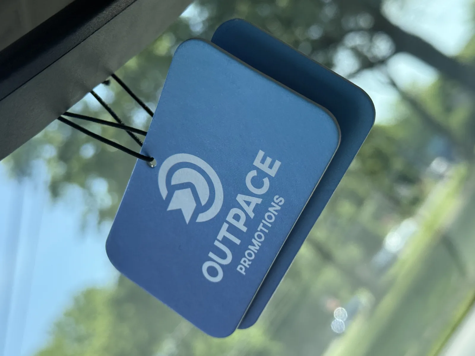 Outpace Promotions mark on a blue branded product sample