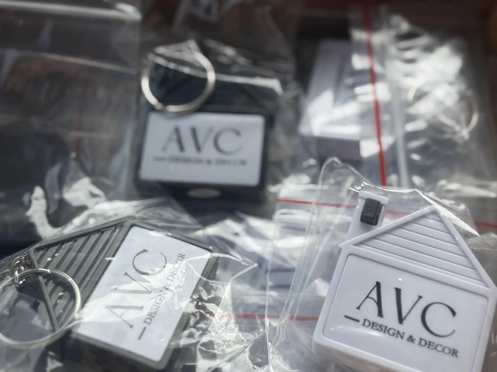House-shaped keychains with AVC Design & Decor branding