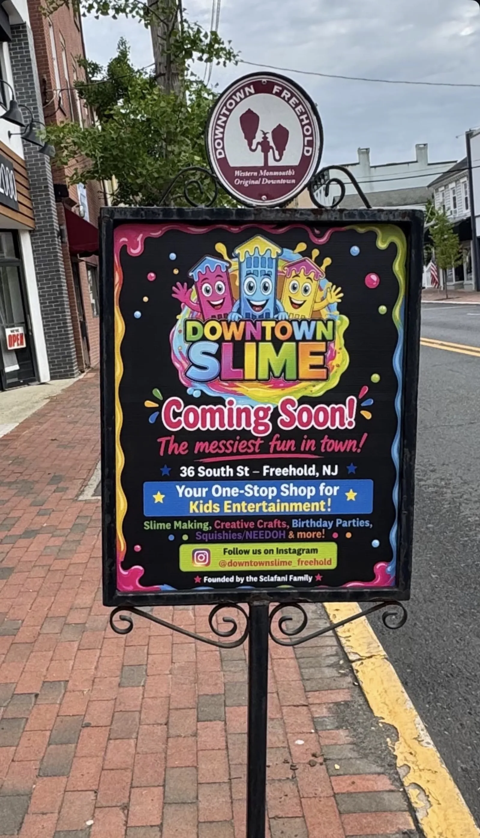Downtown Slime coming-soon sign displayed outside a storefront